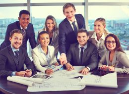 Group of business partners looking at camera with smiles in office